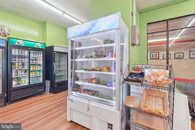 interior space featuring beverage cooler and wood finished floors