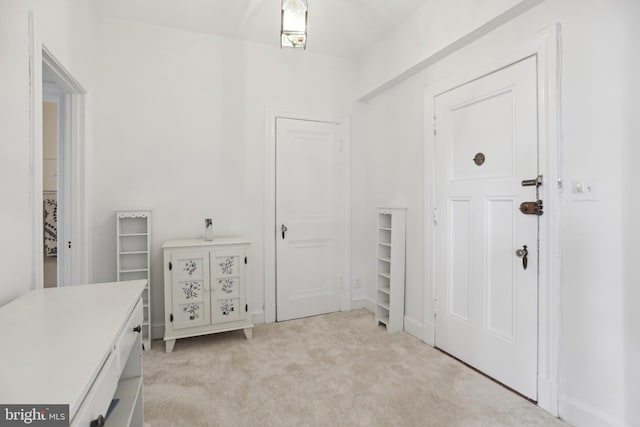 entrance foyer featuring light colored carpet