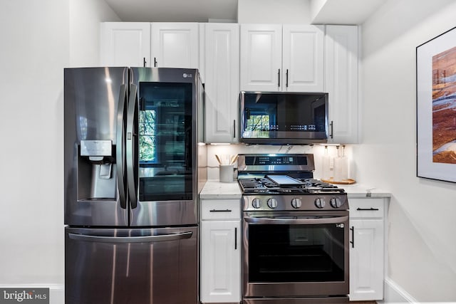 kitchen featuring white cabinets and appliances with stainless steel finishes