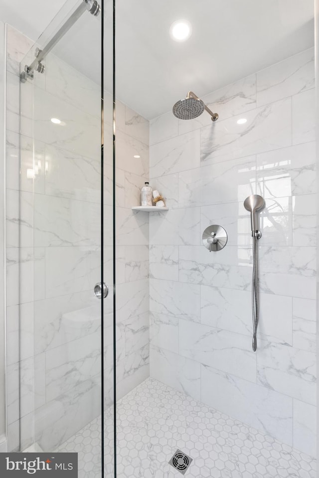 bathroom with a marble finish shower