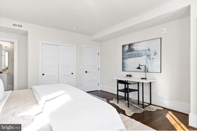 bedroom with visible vents, baseboards, a closet, and dark wood-style flooring