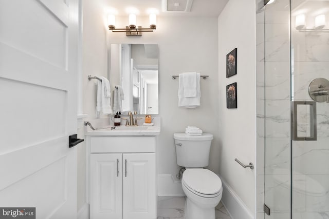 full bath featuring toilet, marble finish floor, a marble finish shower, baseboards, and vanity