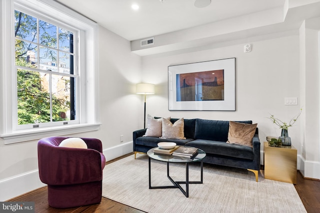 living room with recessed lighting, wood finished floors, visible vents, and baseboards