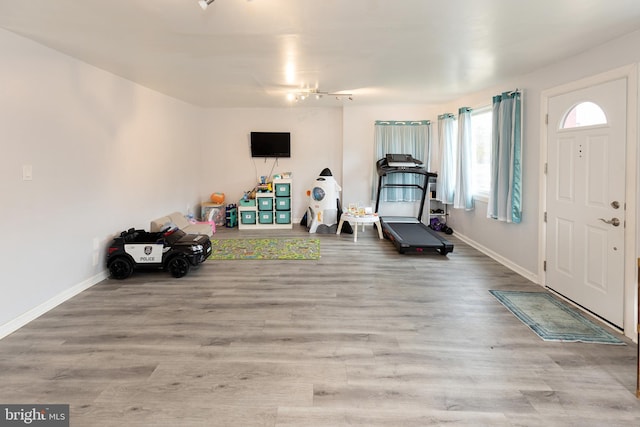 interior space with wood finished floors and baseboards