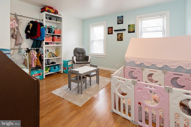 bedroom featuring wood finished floors and baseboards