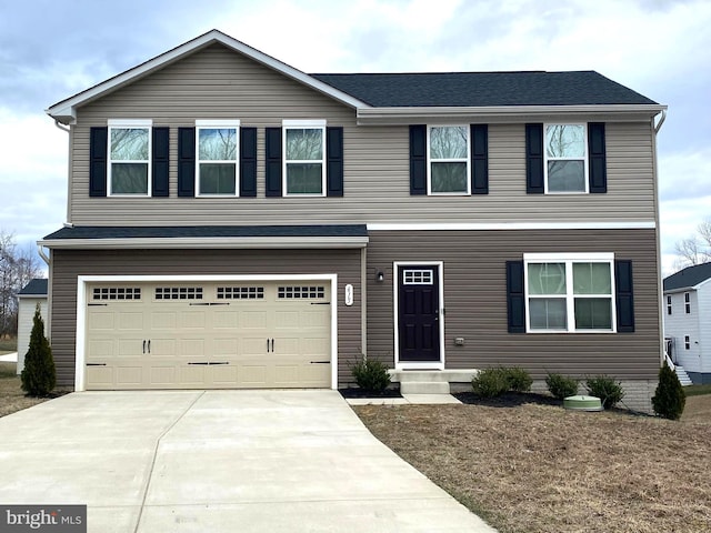 view of front of property with concrete driveway and an attached garage