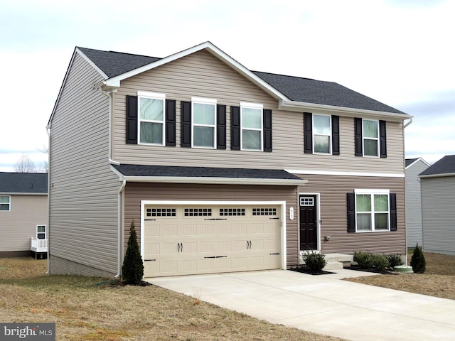 view of front of property featuring concrete driveway and an attached garage