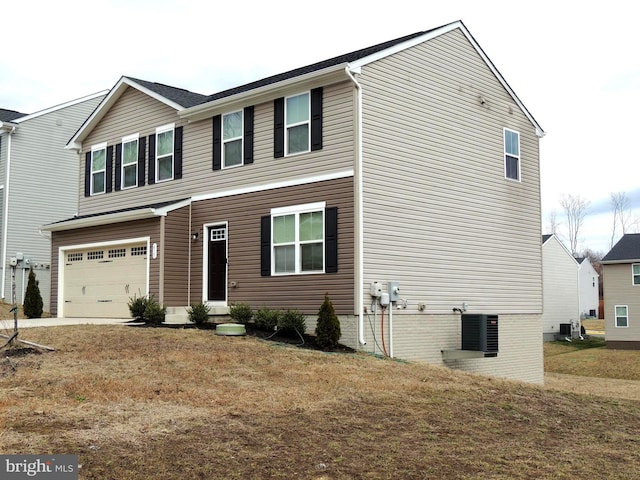 view of front of home with central AC unit and an attached garage