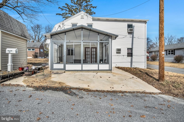 back of house with a sunroom and a patio area