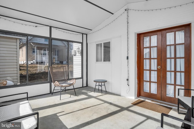 sunroom / solarium featuring lofted ceiling and french doors