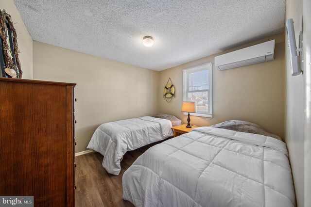 5909 Ocean Blvd, Long Beach Township, NJ 08008 - bedroom featuring an AC wall unit, wood finished floors, and a textured ceiling