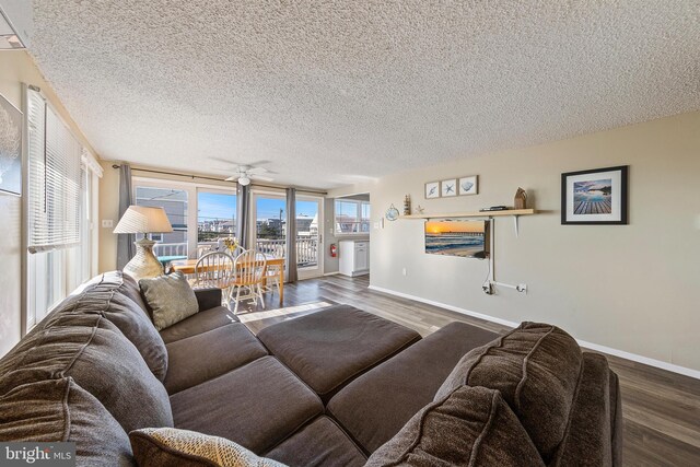 5909 Ocean Blvd, Long Beach Township, NJ 08008 - living area featuring a textured ceiling, a ceiling fan, baseboards, and wood finished floors
