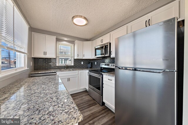 5909 Ocean Blvd, Long Beach Township, NJ 08008 - kitchen featuring dark wood-style floors, appliances with stainless steel finishes, white cabinetry, and a sink