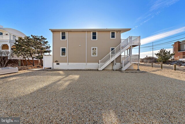 5909 Ocean Blvd, Long Beach Township, NJ 08008 - rear view of house with stairs, fence, and crawl space