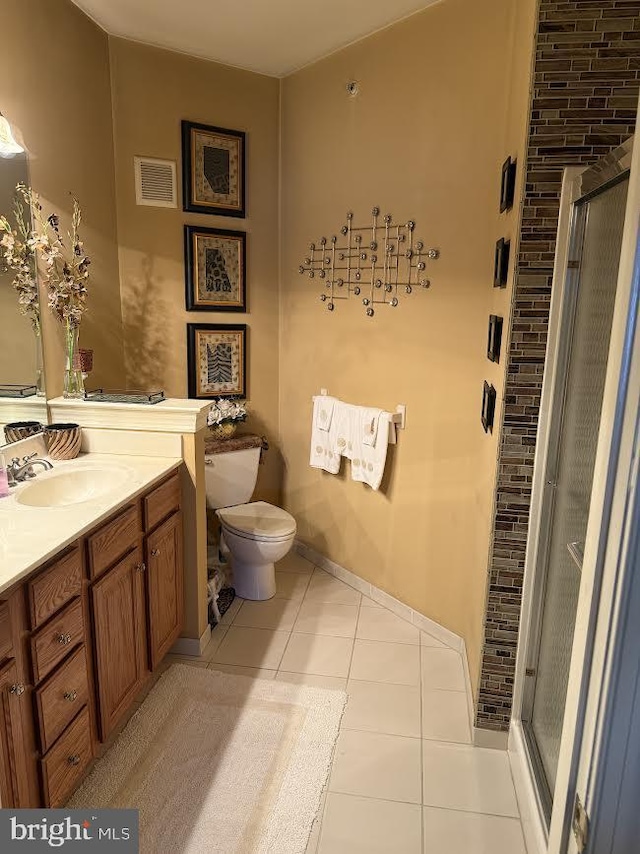 full bathroom featuring a stall shower, vanity, visible vents, and tile patterned floors