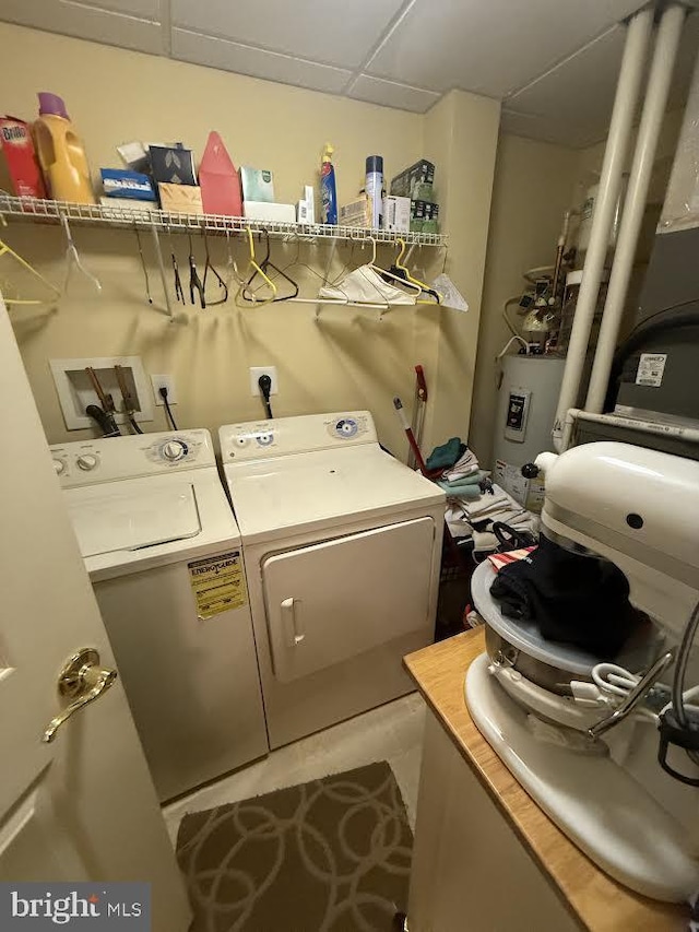 laundry room with washer and dryer, laundry area, and water heater