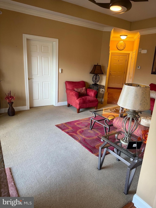 carpeted living area featuring ornamental molding and baseboards