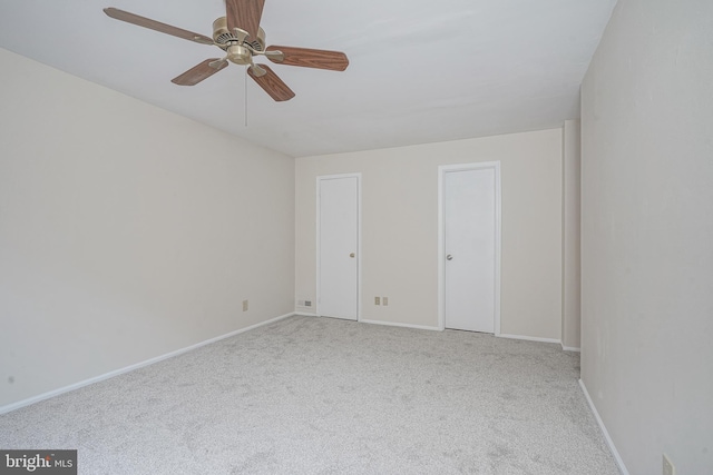 unfurnished room featuring ceiling fan, carpet flooring, and baseboards