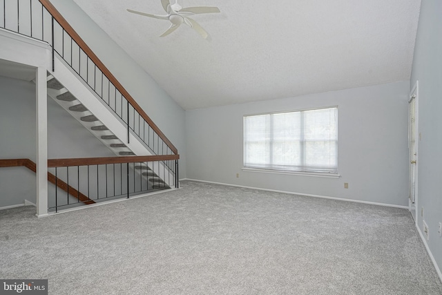 unfurnished living room featuring carpet floors, baseboards, a ceiling fan, and lofted ceiling