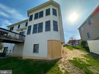 back of house featuring a wooden deck