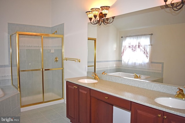 full bathroom featuring tile patterned floors, a garden tub, and a sink