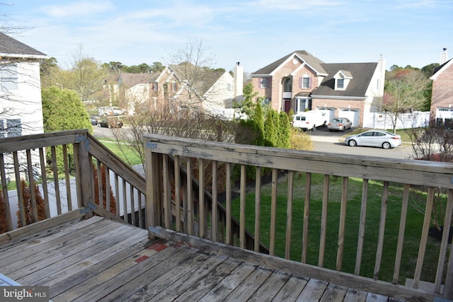 deck featuring a lawn and a residential view