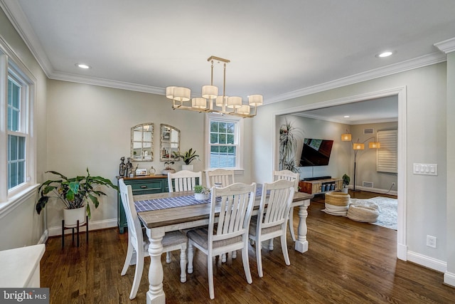 dining area with crown molding, wood finished floors, and baseboards