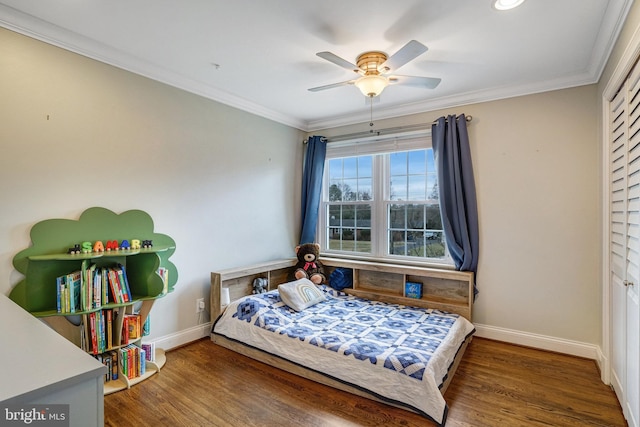 bedroom with ornamental molding, wood finished floors, and baseboards