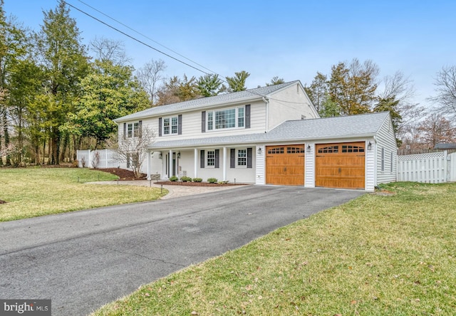 view of front of house featuring aphalt driveway, an attached garage, a shingled roof, fence, and a front lawn