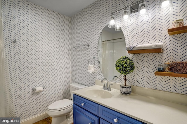 bathroom with toilet, a shower with shower curtain, and vanity