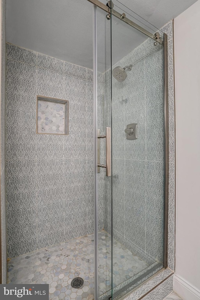 full bath with a shower stall