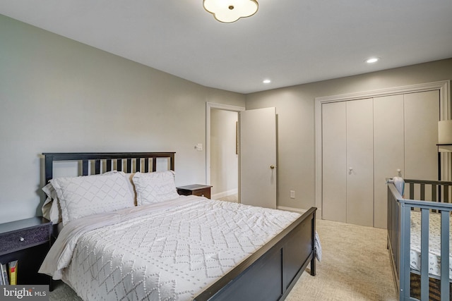 bedroom featuring light carpet, a closet, and recessed lighting