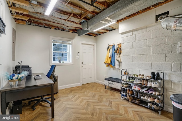 office space with concrete block wall and baseboards