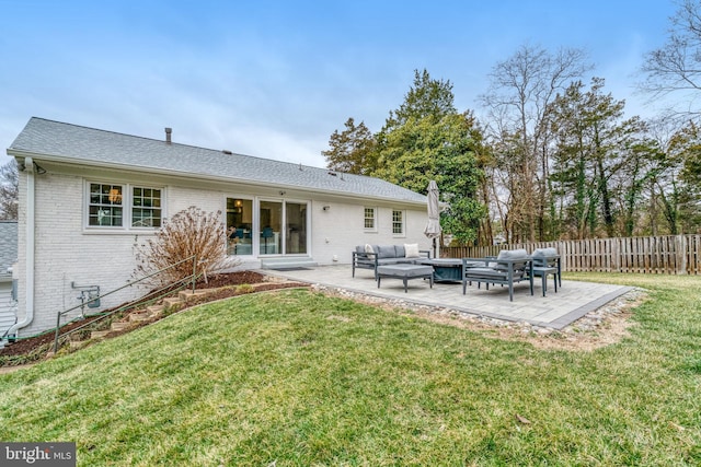 back of house with a patio, brick siding, outdoor lounge area, fence, and a yard