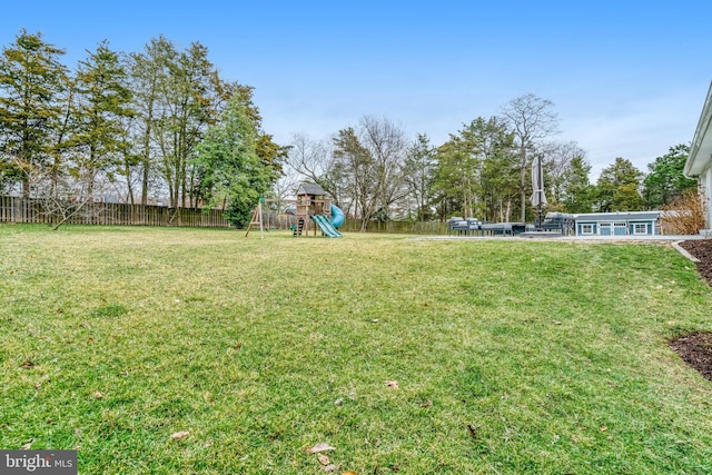 view of yard with a playground and fence