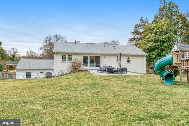 rear view of house with a playground, a patio, a lawn, central AC unit, and fence