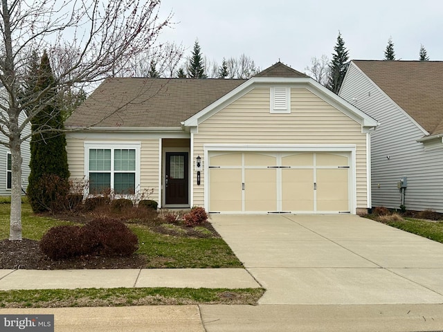 ranch-style home with an attached garage, driveway, and roof with shingles