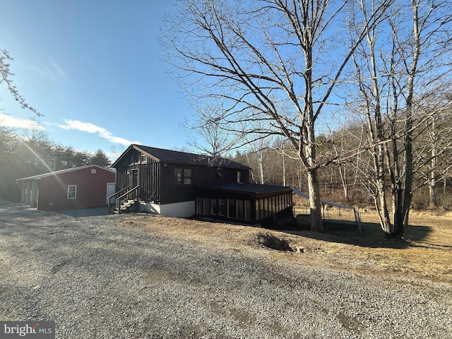 view of home's exterior with entry steps and a deck