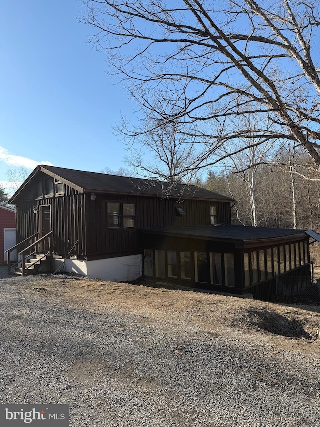 exterior space with entry steps and board and batten siding