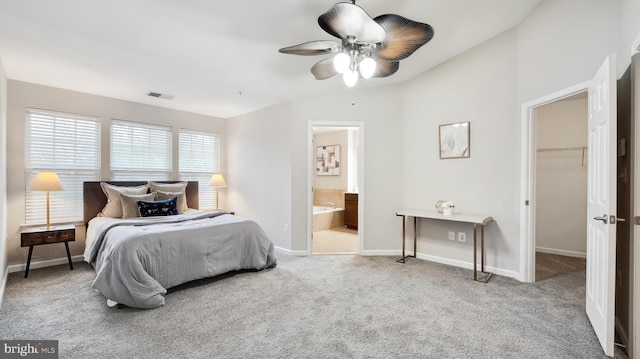 bedroom with baseboards, visible vents, ensuite bathroom, a walk in closet, and carpet floors