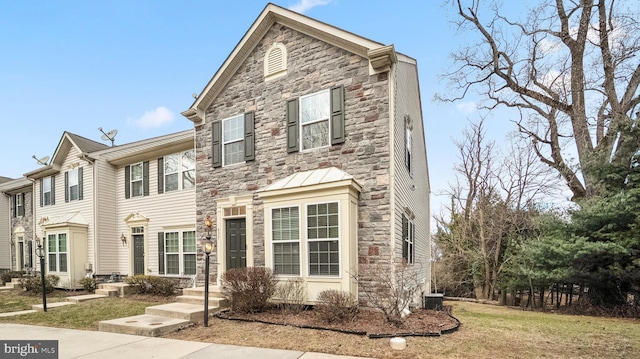 view of front of property featuring cooling unit and stone siding