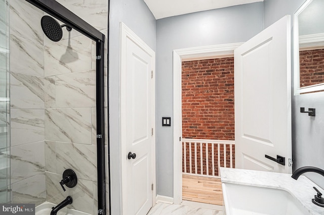 5126 N Sydenham St, Philadelphia, PA 19141 - bathroom with brick wall, shower / bathtub combination, marble finish floor, and a sink