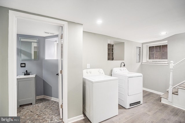 5126 N Sydenham St, Philadelphia, PA 19141 - clothes washing area featuring light wood finished floors, a sink, baseboards, and washer and clothes dryer