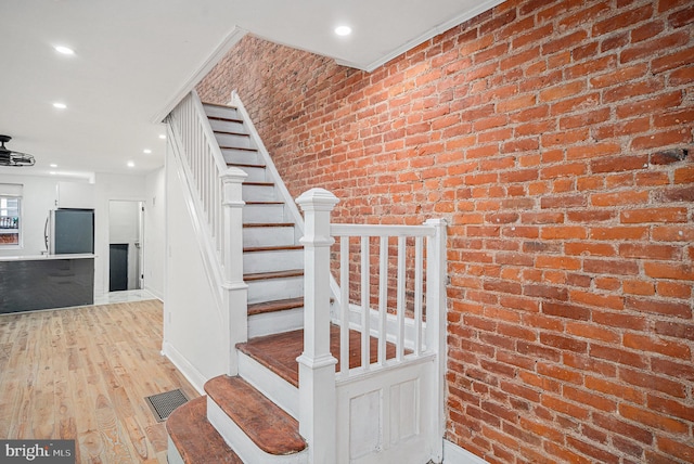 5126 N Sydenham St, Philadelphia, PA 19141 - stairway featuring visible vents, recessed lighting, wood finished floors, brick wall, and baseboards