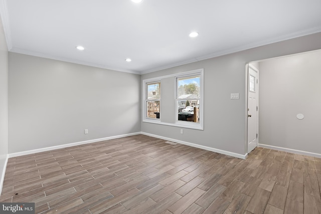 unfurnished room featuring crown molding, baseboards, and wood finished floors