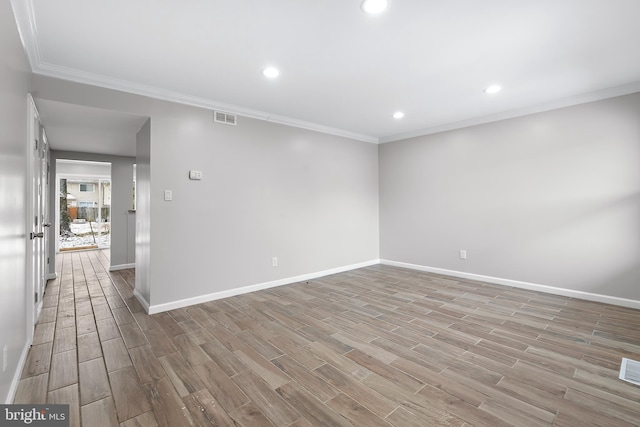 unfurnished room with visible vents, crown molding, and light wood finished floors