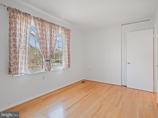 interior space with a healthy amount of sunlight, baseboards, and wood finished floors