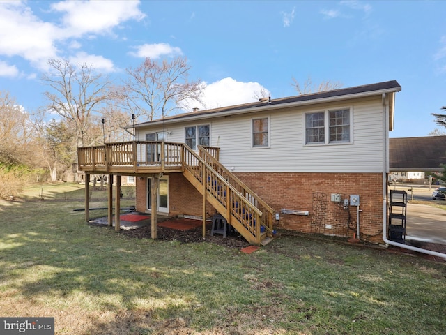 rear view of house with brick siding, a yard, stairway, a patio area, and a deck