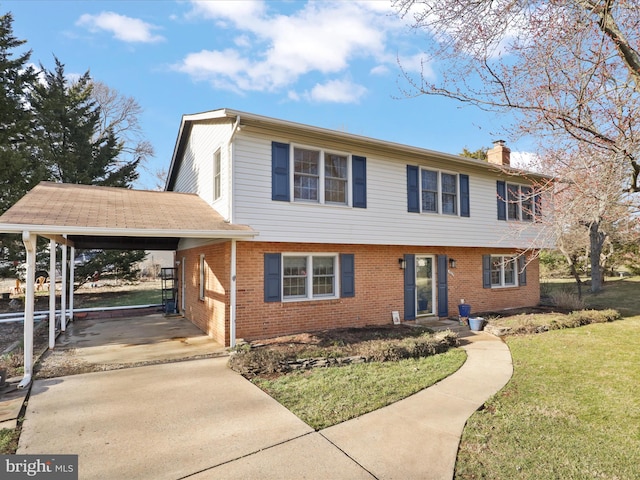 colonial-style house featuring brick siding, driveway, a carport, a front lawn, and a chimney