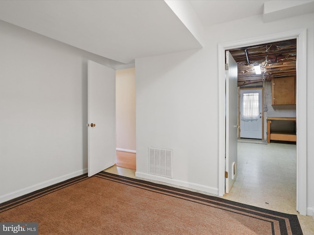 unfurnished room featuring baseboards, visible vents, and tile patterned floors